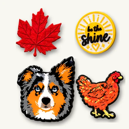 Four Cohjoy skins: small multicolour 3D-printed designs on badge reels