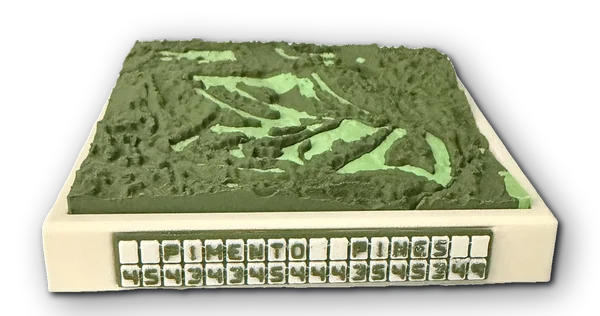 Photo of the real PIMENTO PINES from the front: a green golf course relief in a cream tray, its nameplate reading PIMENTO PINES with the course's pars